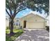 Charming single-story home with a two-car garage and well-maintained landscaping at 124 Lancaster Dr, Davenport, FL 33897