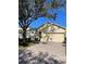 Attractive one-story home with a large tree and brick driveway at 124 Lancaster Dr, Davenport, FL 33897