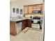 Modern kitchen features stainless steel appliances and granite countertops at 124 Lancaster Dr, Davenport, FL 33897