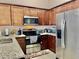 Modern kitchen with granite countertops and stainless steel appliances at 124 Lancaster Dr, Davenport, FL 33897