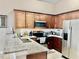 Modern kitchen with granite countertops and stainless steel appliances at 124 Lancaster Dr, Davenport, FL 33897