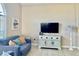 Bright living room with vaulted ceiling, comfy couches, and a large window at 124 Lancaster Dr, Davenport, FL 33897