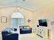 Relaxing living room featuring comfortable sofas and a large TV at 124 Lancaster Dr, Davenport, FL 33897