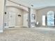 Bright living room featuring neutral decor and carpeted floors at 124 Lancaster Dr, Davenport, FL 33897