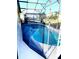 Enclosed kidney shaped pool with safety fence at 124 Lancaster Dr, Davenport, FL 33897