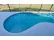 Relaxing kidney shaped pool with safety fence at 124 Lancaster Dr, Davenport, FL 33897