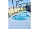 Enclosed kidney shaped pool with safety fence at 124 Lancaster Dr, Davenport, FL 33897