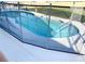 Kidney shaped pool with safety fence at 124 Lancaster Dr, Davenport, FL 33897