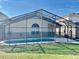 Beautiful screened-in pool area with plenty of space for outdoor seating and entertaining at 124 Lancaster Dr, Davenport, FL 33897