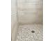 Clean shower with patterned tile floor and neutral wall tiles at 124 Lancaster Dr, Davenport, FL 33897