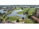 Aerial view of community with golf course and lake at 13265 Alderley Dr, Orlando, FL 32832
