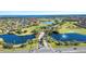 Aerial view showing community entrance and golf course at 13265 Alderley Dr, Orlando, FL 32832