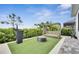 Landscaped backyard with artificial turf and pergola at 13265 Alderley Dr, Orlando, FL 32832