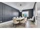 Formal dining room with dark walls, large table and chandelier at 13265 Alderley Dr, Orlando, FL 32832