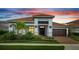 Charming single-story home featuring a tile roof, meticulously landscaped yard, and an attached two-car garage at 13265 Alderley Dr, Orlando, FL 32832
