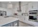 Modern kitchen with white cabinets, stainless steel appliances and patterned backsplash at 13265 Alderley Dr, Orlando, FL 32832