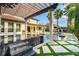 Stunning backyard with a pool, waterfall feature, pergola, and outdoor seating at 13596 Gorgona Isle Dr, Windermere, FL 34786