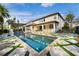 Spacious backyard featuring a refreshing pool, covered patio, and lush surroundings at 13596 Gorgona Isle Dr, Windermere, FL 34786