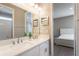 Bathroom features double sinks, white granite countertops, and an adjacent bedroom at 13596 Gorgona Isle Dr, Windermere, FL 34786