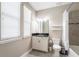 Bright bathroom featuring tile floors, granite vanity with white cabinets, and a shower/tub combo at 13596 Gorgona Isle Dr, Windermere, FL 34786