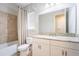 Bathroom features a shower/tub combo, white vanity with granite counter, and decorative shower curtain at 13596 Gorgona Isle Dr, Windermere, FL 34786