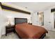 Bedroom showcasing a bed with a dark headboard, gold and black paint accent, and ensuite bath access at 13596 Gorgona Isle Dr, Windermere, FL 34786
