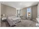 Light-filled bedroom with a wrought iron bed, neutral walls, and a window seat at 13596 Gorgona Isle Dr, Windermere, FL 34786