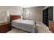Cozy bedroom with a wooden bed frame, neutral paint, bedside table, and natural light at 13596 Gorgona Isle Dr, Windermere, FL 34786