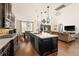 Open concept kitchen with dark wood cabinets, white countertops, and seamless flow to living area at 13596 Gorgona Isle Dr, Windermere, FL 34786