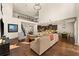 Open-concept living room featuring wood floors, high ceilings, staircase, and seamless flow to kitchen at 13596 Gorgona Isle Dr, Windermere, FL 34786