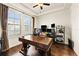 Home office with wood floors, a large desk, and natural light from the window at 13596 Gorgona Isle Dr, Windermere, FL 34786