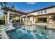 Beautiful pool with a pergola, outdoor seating, and manicured landscaping at 13596 Gorgona Isle Dr, Windermere, FL 34786