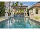 Lush backyard and pool area with ornate columns and water feature at 13596 Gorgona Isle Dr, Windermere, FL 34786