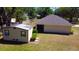 Aerial view of the home with a storage shed in the backyard at 18148 Villa City Rd, Groveland, FL 34736