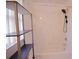 Bathroom with shower-tub combo and black shelving unit at 18148 Villa City Rd, Groveland, FL 34736