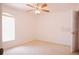 Neutral bedroom featuring a ceiling fan and a large window for ample natural light at 18148 Villa City Rd, Groveland, FL 34736