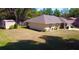 Exterior view of the home with spacious backyard and detached shed at 18148 Villa City Rd, Groveland, FL 34736