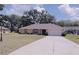Cozy one-story home with a well-manicured lawn and a long driveway at 18148 Villa City Rd, Groveland, FL 34736