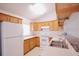 Efficient kitchen featuring wood cabinets and appliances at 18148 Villa City Rd, Groveland, FL 34736