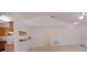 Bright living room with vaulted ceiling and breakfast bar overlooking modern kitchen with tan cabinets at 18148 Villa City Rd, Groveland, FL 34736