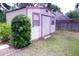 Exterior view of a backyard storage shed with a roll-up door at 18148 Villa City Rd, Groveland, FL 34736