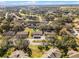 An elevated view displays the townhomes with scenic landscaping and surrounded by mature trees for a lovely community at 2214 Se Sawgrass Ct, Winter Haven, FL 33884