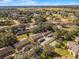 A high-angle view shows the townhomes with lush landscaping and surrounding greenery for a picturesque setting at 2214 Se Sawgrass Ct, Winter Haven, FL 33884