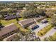 Scenic aerial of townhomes with individual carports surrounded by a green landscape with trees, a serene community at 2214 Se Sawgrass Ct, Winter Haven, FL 33884