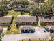 An aerial view of well-maintained townhomes with carports and green spaces in a vibrant, landscaped community at 2214 Se Sawgrass Ct, Winter Haven, FL 33884