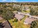 Wide aerial perspective of townhomes, revealing serene green spaces, trees, and winding roads in a peaceful community at 2214 Se Sawgrass Ct, Winter Haven, FL 33884