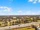Expansive view overlooking a green landscape dotted with trees, and a golf course, next to the highway at 2214 Se Sawgrass Ct, Winter Haven, FL 33884