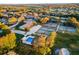 An aerial landscape featuring community tennis courts, a swimming pool, and golf course fairways at 2214 Se Sawgrass Ct, Winter Haven, FL 33884