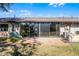 View of the home's patio featuring brick, sliding glass doors, and well-maintained lawn at 2214 Se Sawgrass Ct, Winter Haven, FL 33884