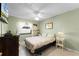 Cozy bedroom featuring tile flooring, a ceiling fan, and a window with natural light at 2214 Se Sawgrass Ct, Winter Haven, FL 33884